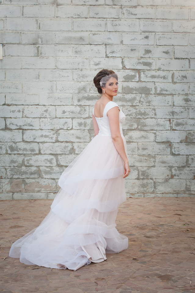 Soft pink and white wedding gown with large frills – UNVEILED SA